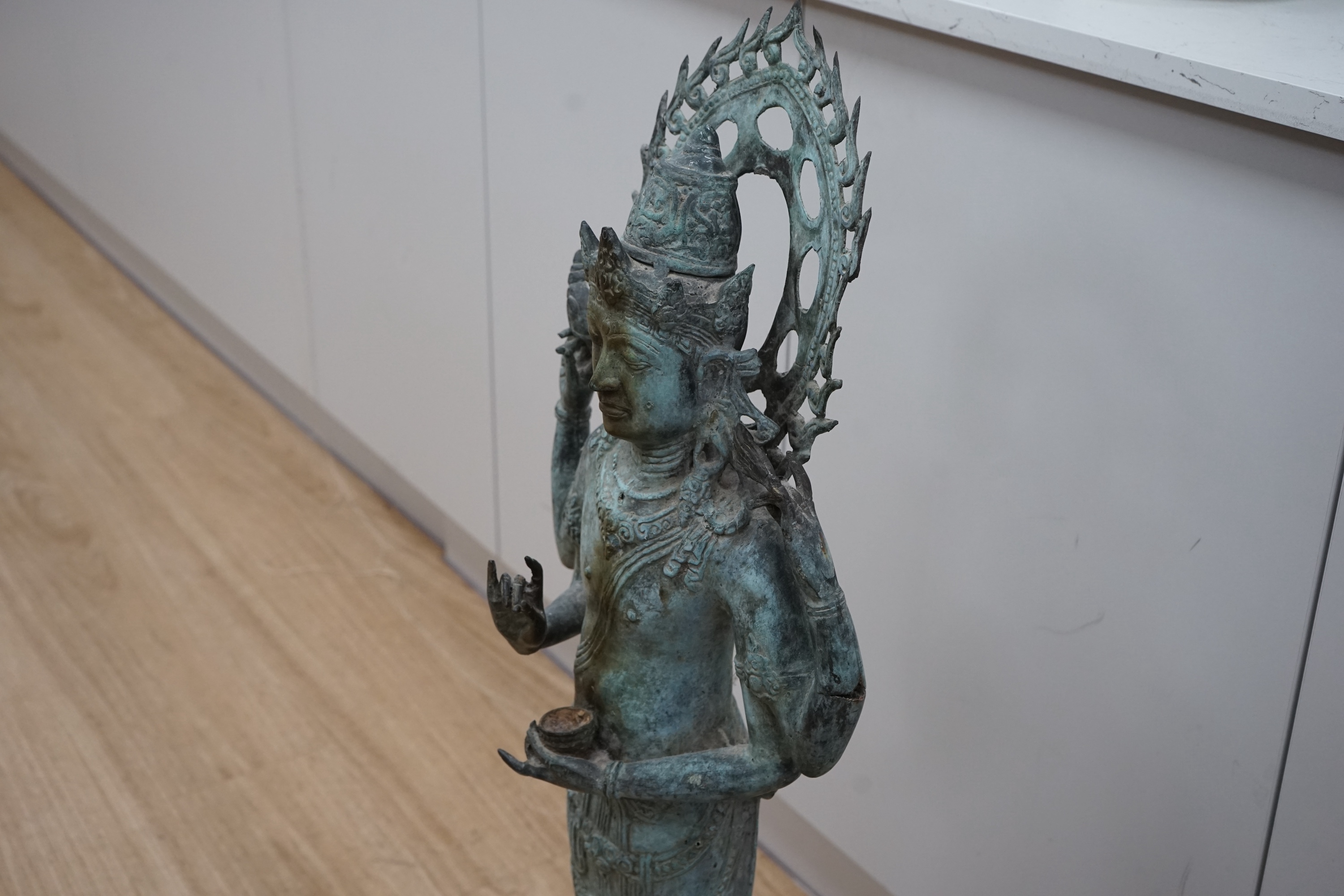 A mid to late century spelter figure of Vishnu, 93cm high. Condition - hands from incense or a candle being lit.